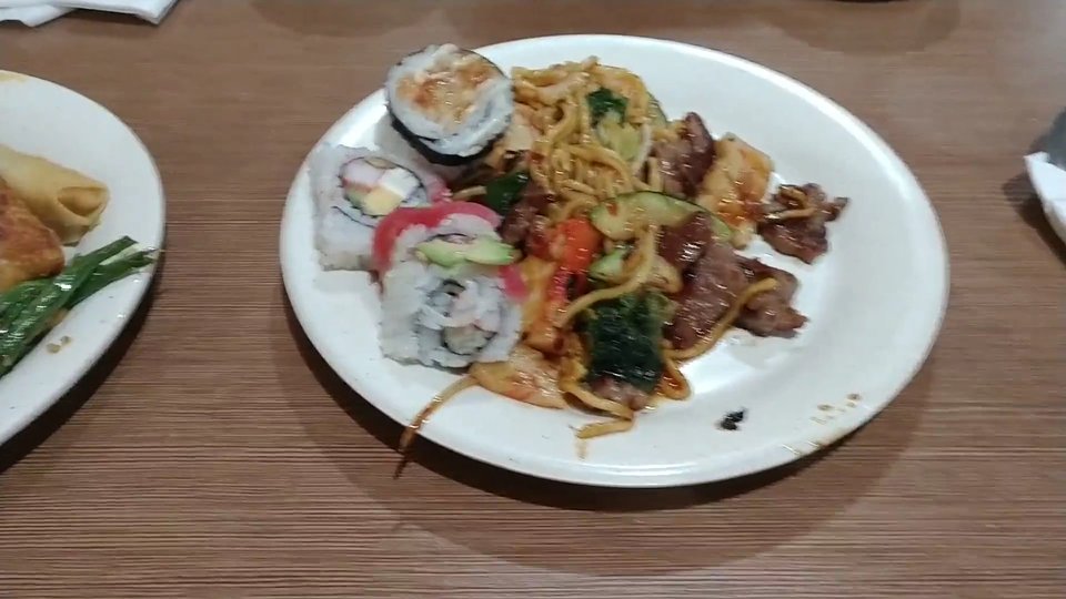 Buffet trays lined with sushi and hot dishes